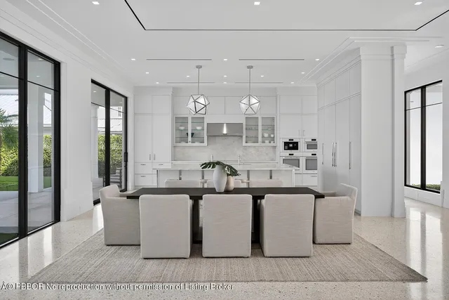 a living room with furniture a flat screen tv and a floor to ceiling window