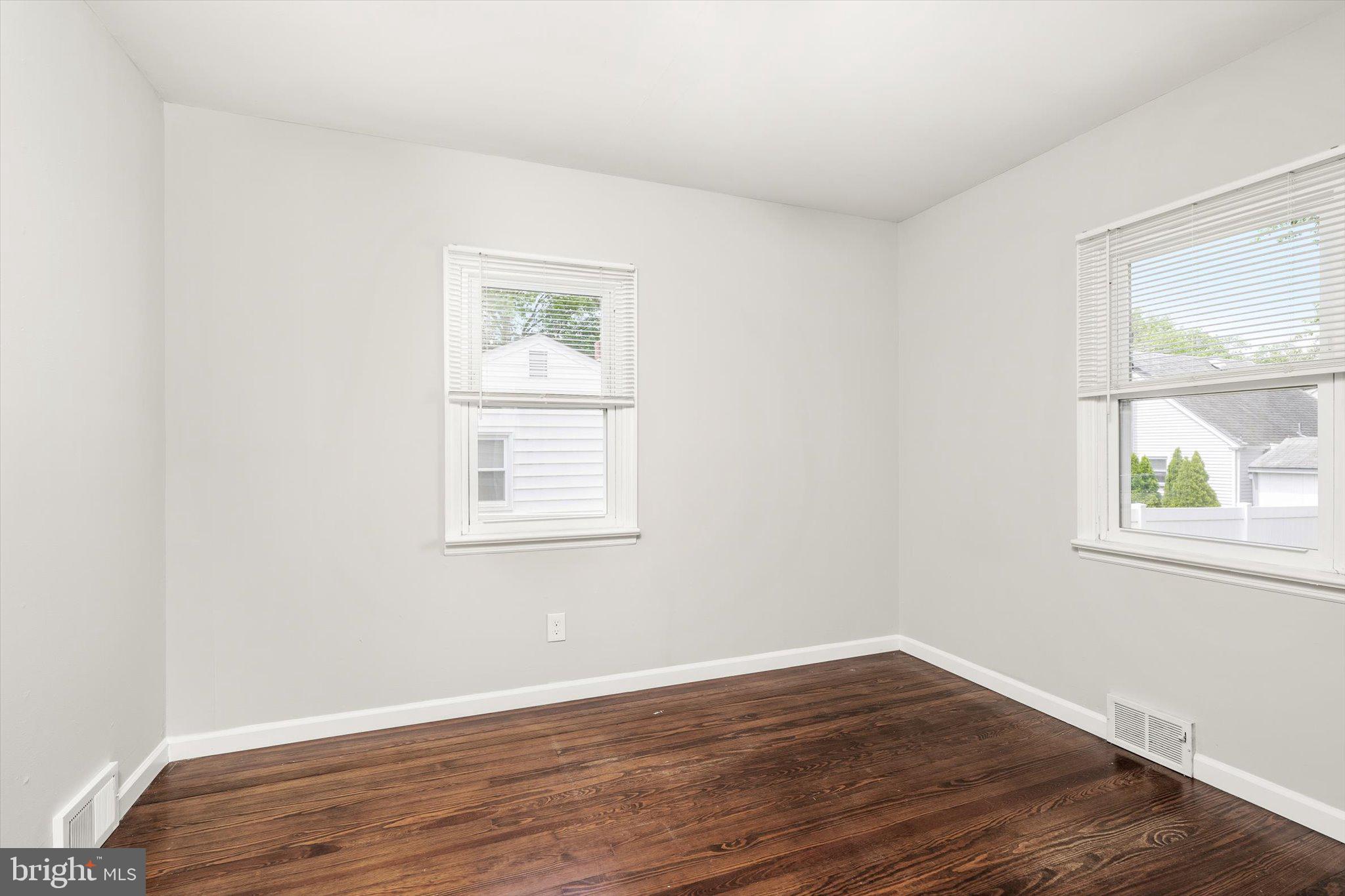 415 Pine Street Florence, NJ 08518 - Photo 11 of 25 an empty room with wooden floor and windows