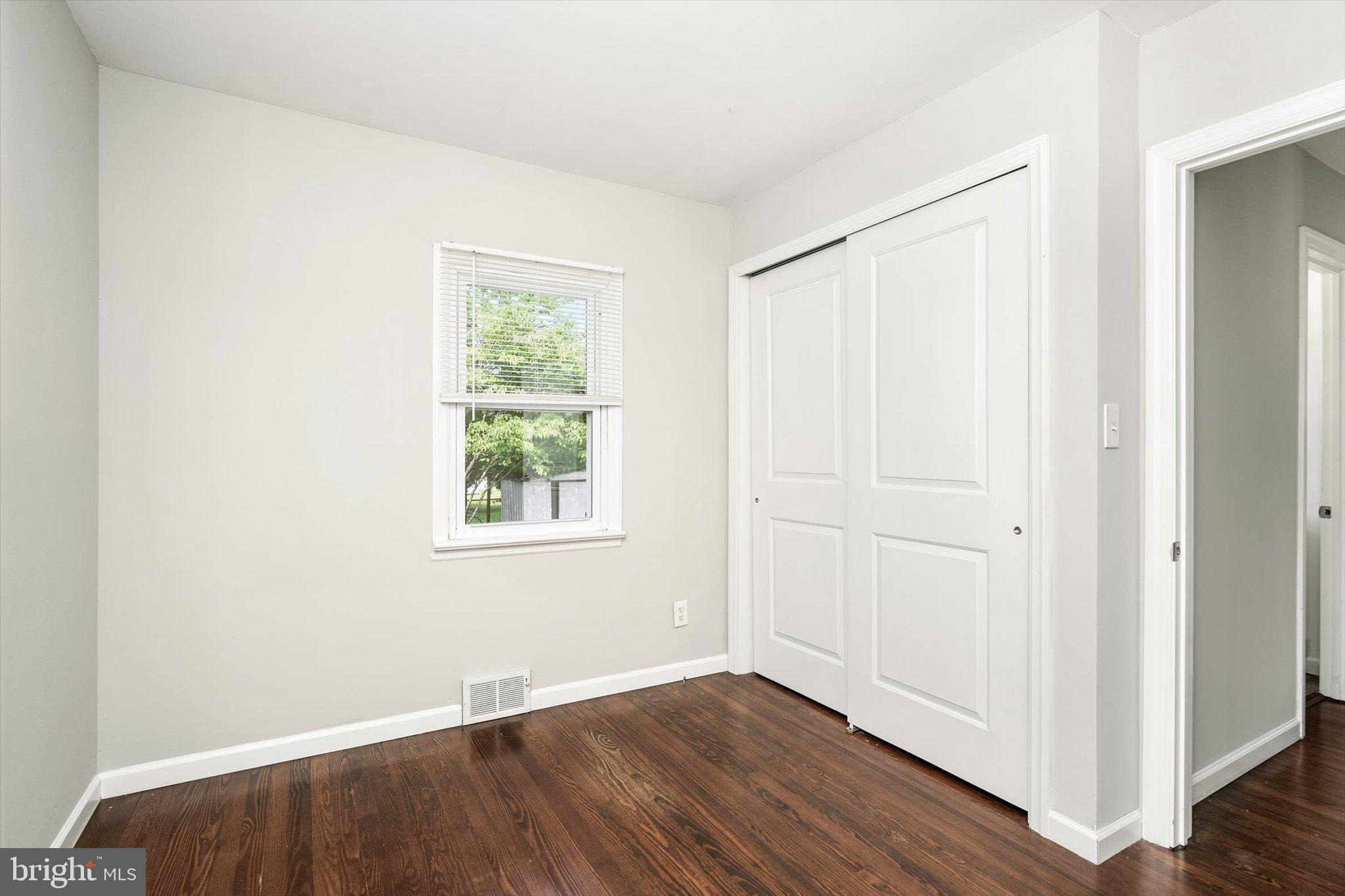 415 Pine Street Florence, NJ 08518 - Photo 12 of 25 an empty room with wooden floor and windows