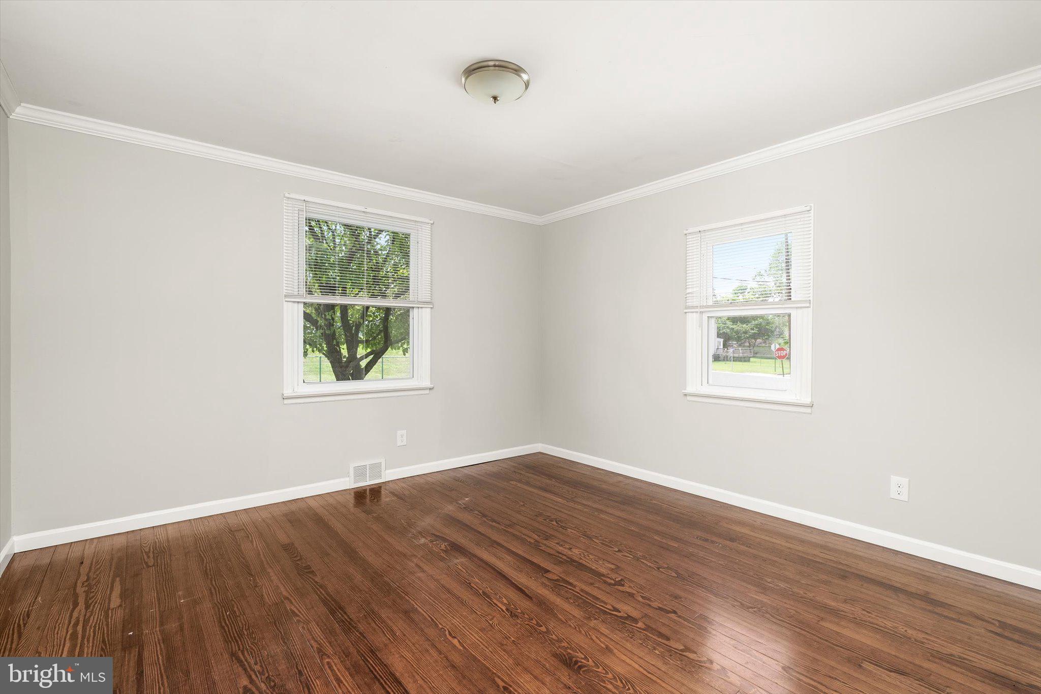 415 Pine Street Florence, NJ 08518 - Photo 13 of 25 an empty room with wooden floor and windows