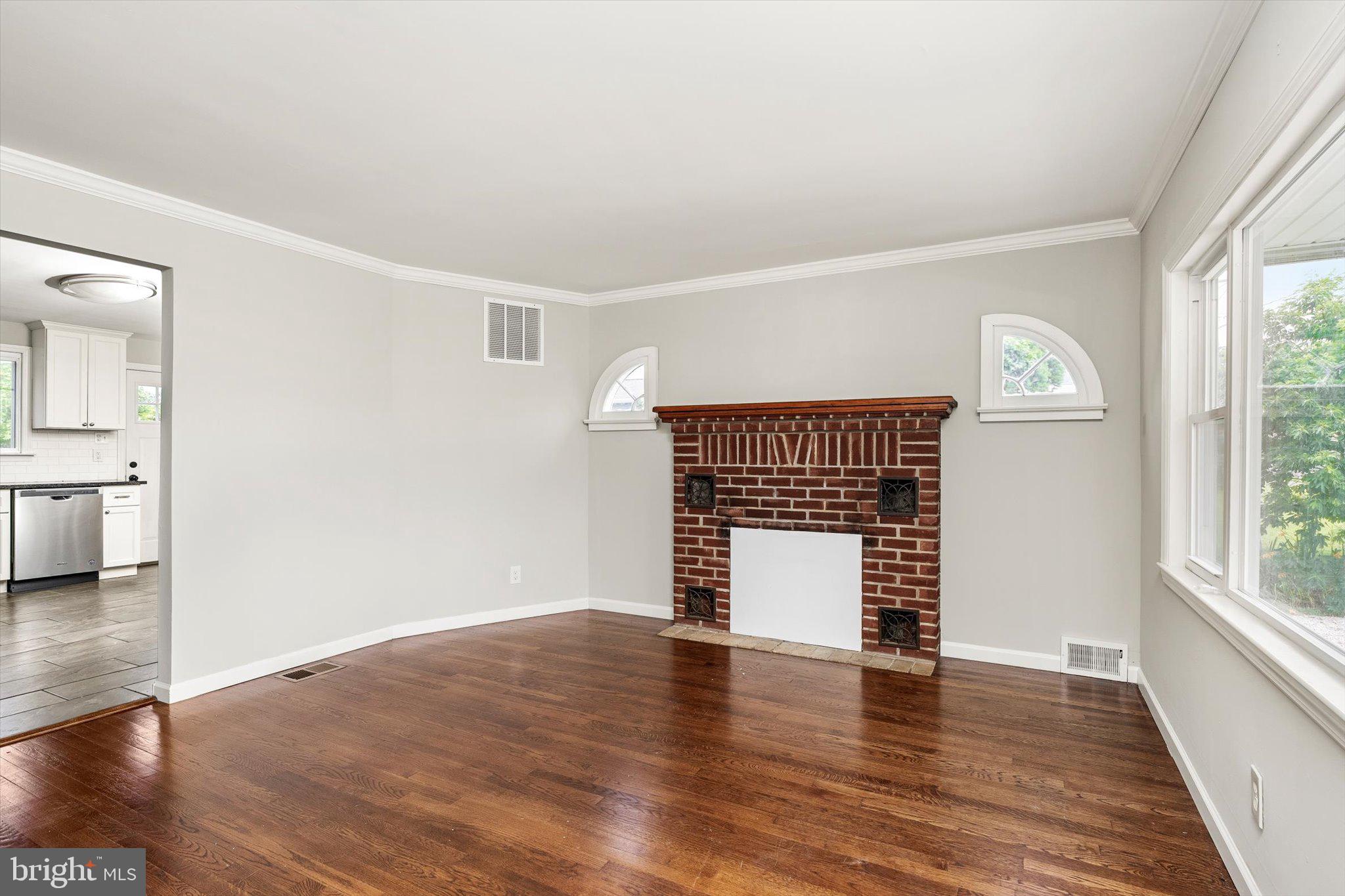 415 Pine Street Florence, NJ 08518 - Photo 3 of 25 an empty room with wooden floor cabinet and windows