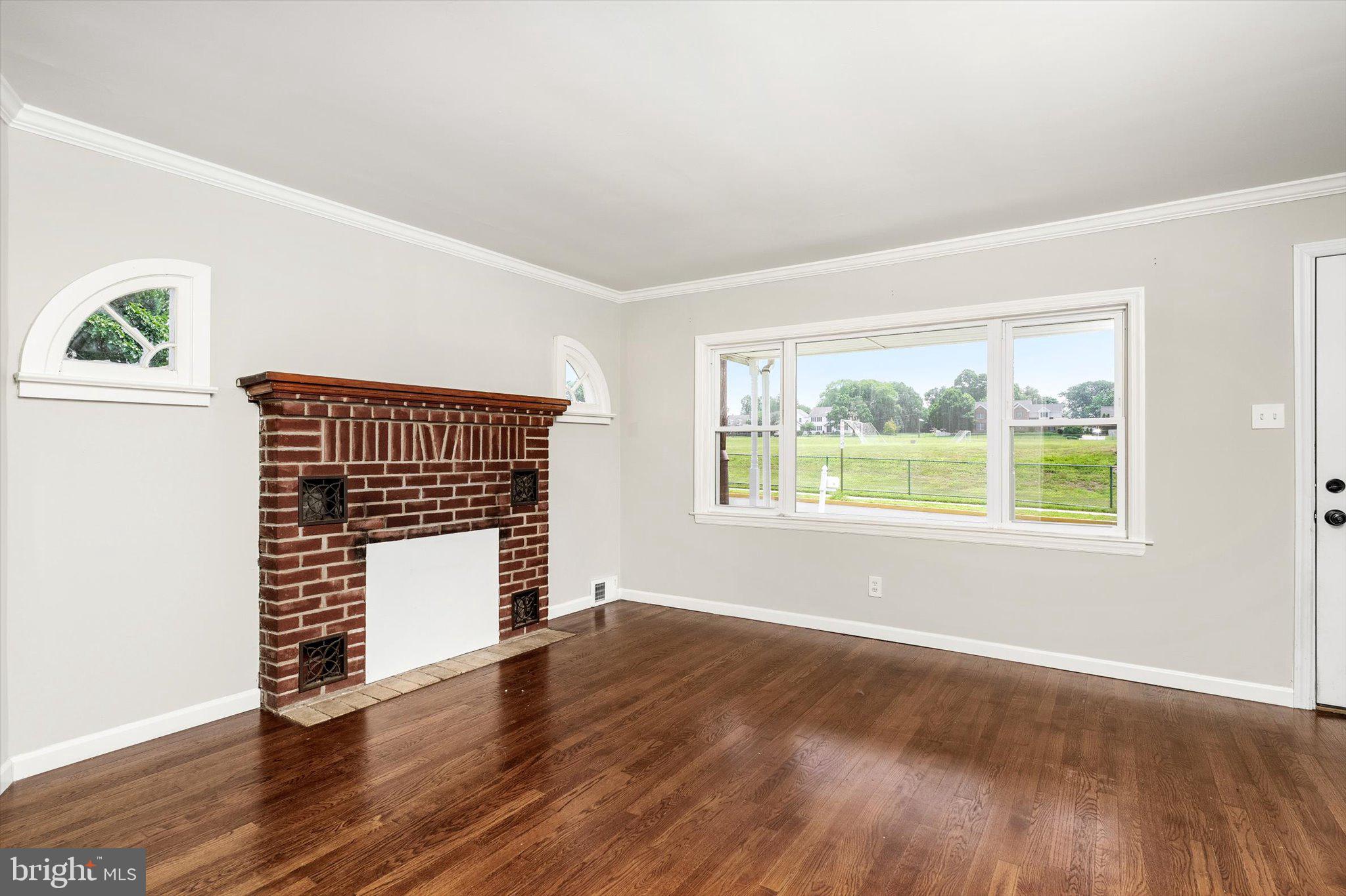 415 Pine Street Florence, NJ 08518 - Photo 4 of 25 an empty room with wooden floor and windows