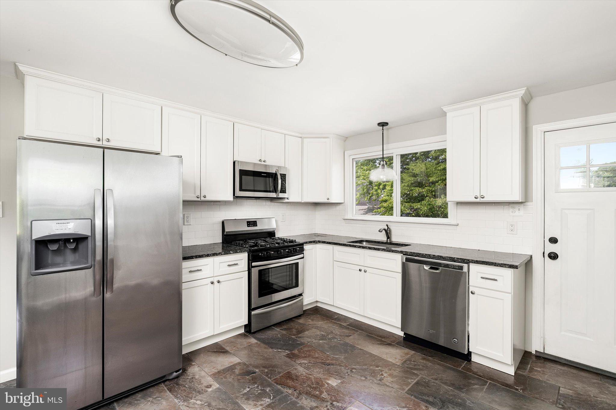 415 Pine Street Florence, NJ 08518 - Photo 7 of 25 a kitchen with stainless steel appliances granite countertop a stove a sink dishwasher a refrigerator and a microwave