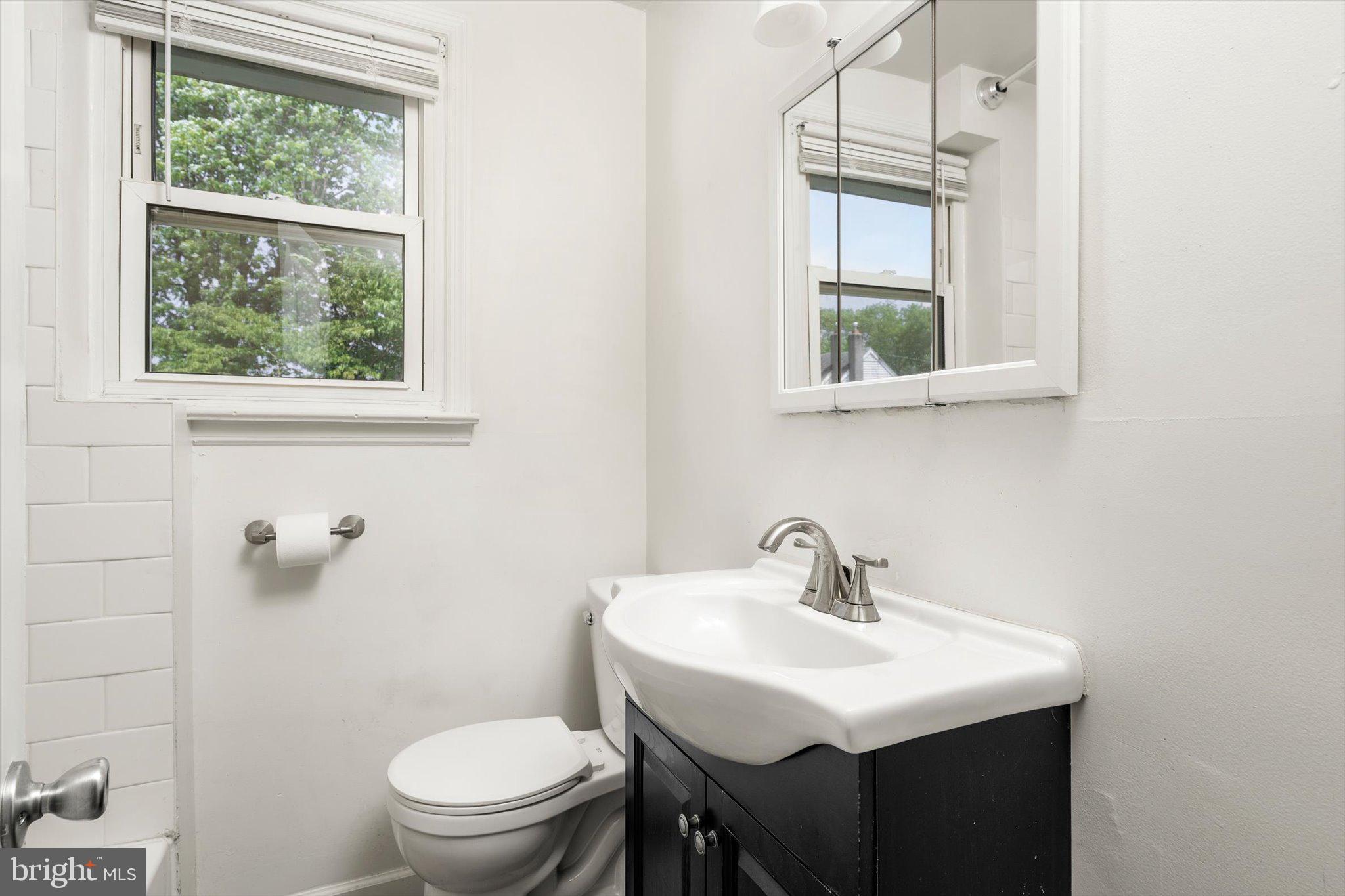 415 Pine Street Florence, NJ 08518 - Photo 9 of 25 a bathroom with a sink a toilet and a window