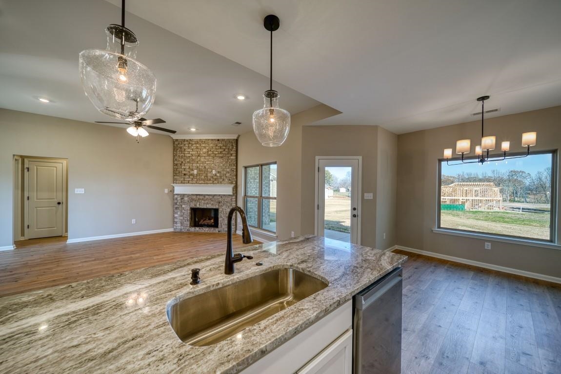 142 Como Lane Atoka, TN 38004 - Photo 9 of 33 Kitchen with light wood finished floors, white cabinets, pendant lighting, a fireplace, and recessed lighting