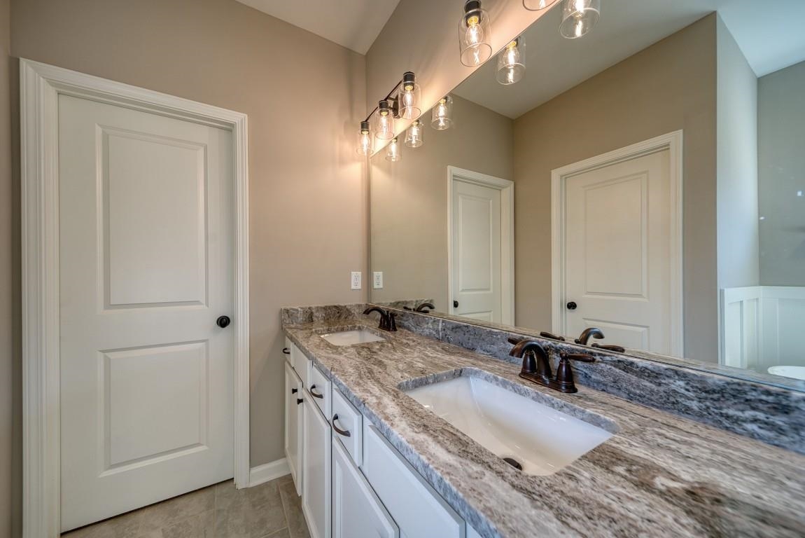142 Como Lane Atoka, TN 38004 - Photo 21 of 33 a bathroom with a granite countertop double vanity sink and a mirror