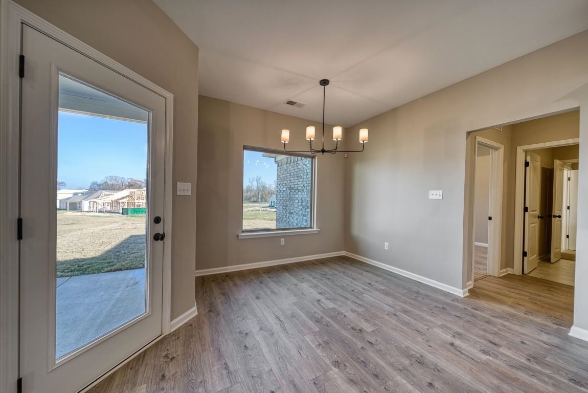 142 Como Lane Atoka, TN 38004 - Photo 27 of 33 a view of an empty room with wooden floor and a window