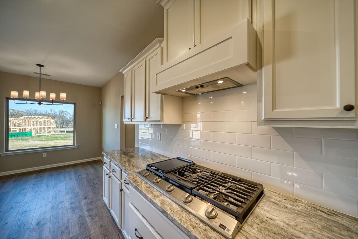 142 Como Lane Atoka, TN 38004 - Photo 6 of 33 a kitchen with a stove a sink and wooden floor