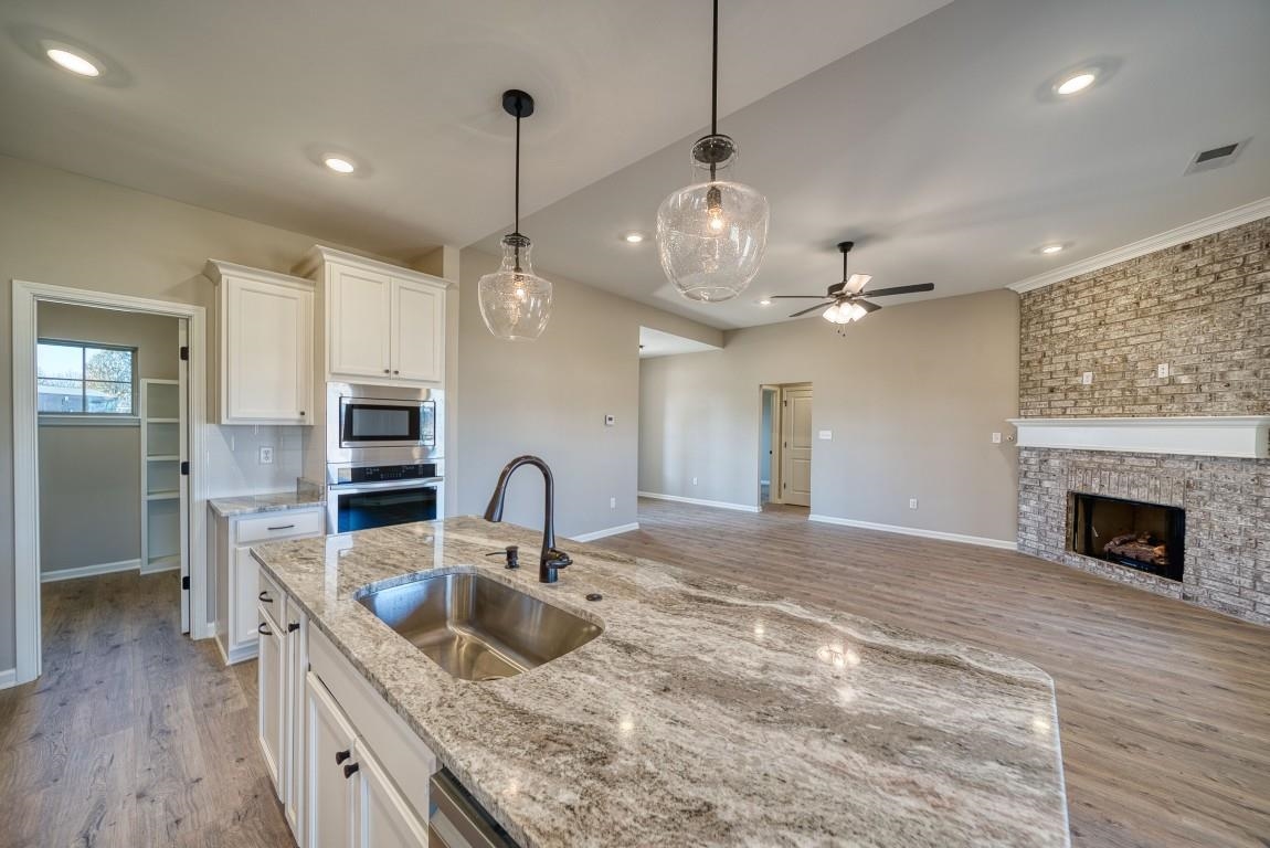 142 Como Lane Atoka, TN 38004 - Photo 32 of 33 a kitchen with stainless steel appliances granite countertop a sink a stove and a wooden floors
