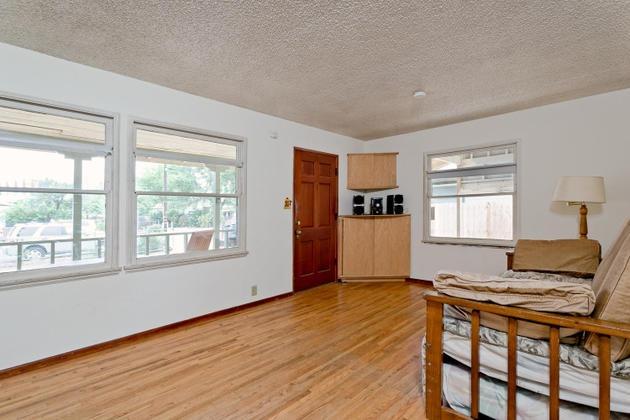 210 Sunset Avenue Oak View, CA 93022 - Photo 3 of 15 a living room with a stove and wooden floor