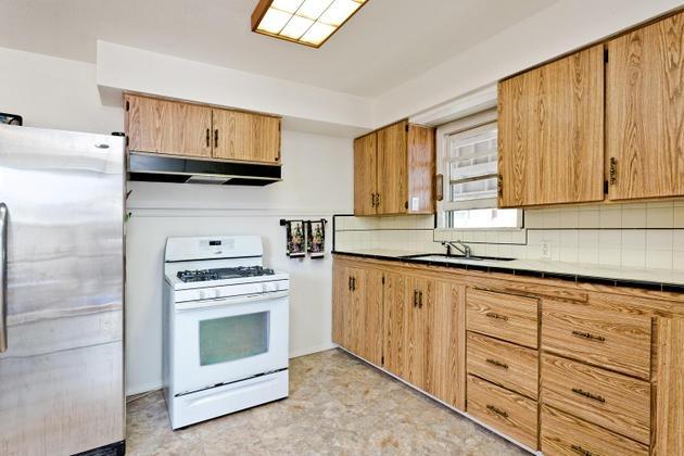 210 Sunset Avenue Oak View, CA 93022 - Photo 6 of 15 a kitchen with granite countertop cabinets stainless steel appliances and wooden floor