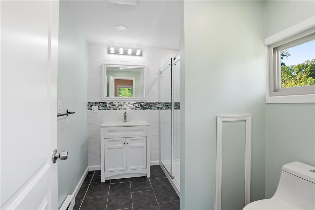 6271 Batman Road Zionsville, PA 18092 - Photo 80 of 100 A well-appointed bath features a tiled walk-in shower and a modern vanity.