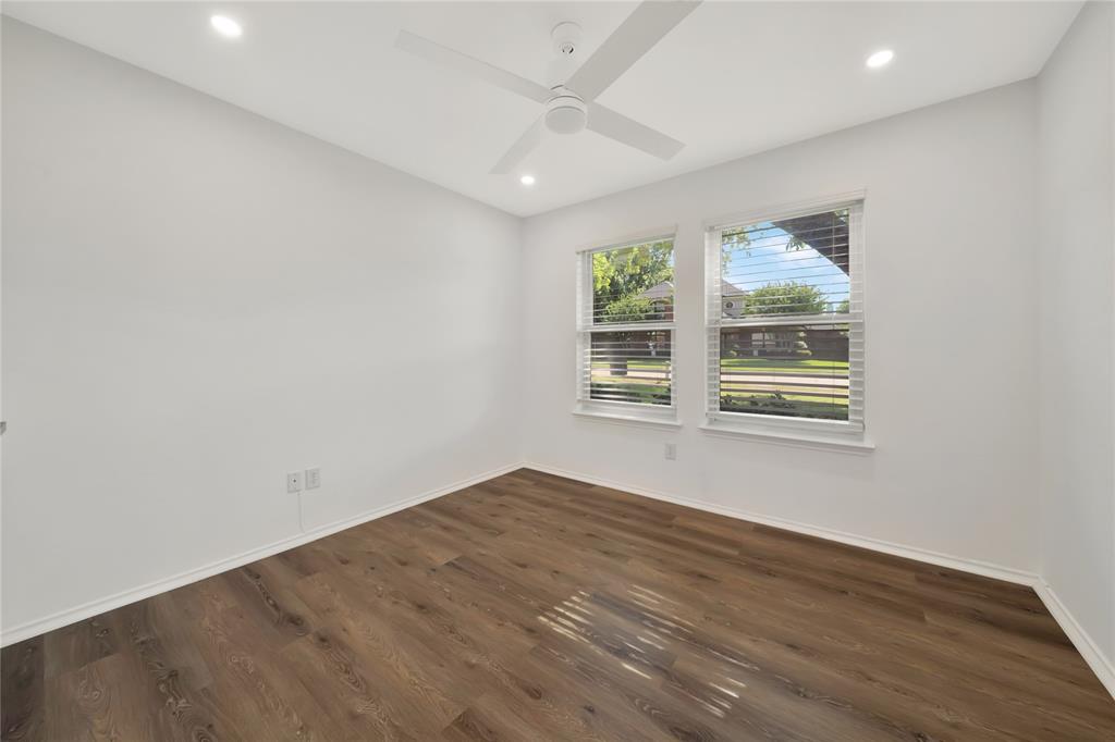 2909 Normandy Court Euless, TX 76039 - Photo 20 of 36 an empty room with wooden floor and windows
