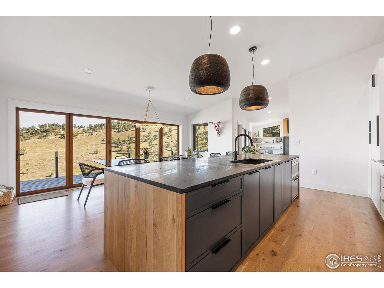 5880 Olde Stage Road Boulder, CO 80302 - Photo 19 of 50 a kitchen with a wooden floor and a large window