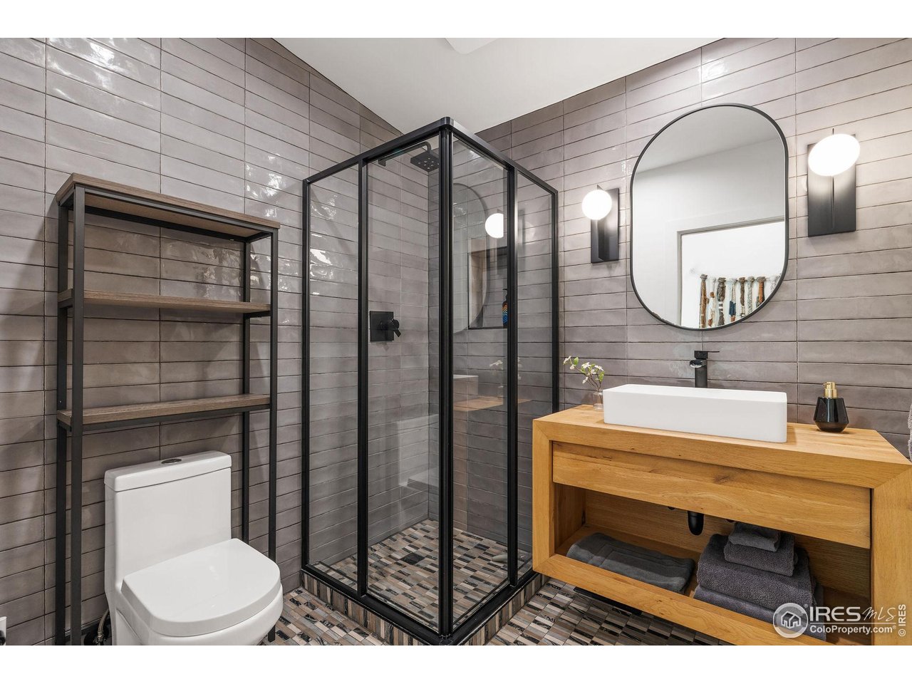 5880 Olde Stage Road Boulder, CO 80302 - Photo 38 of 50 a bathroom with a toilet a sink and mirror