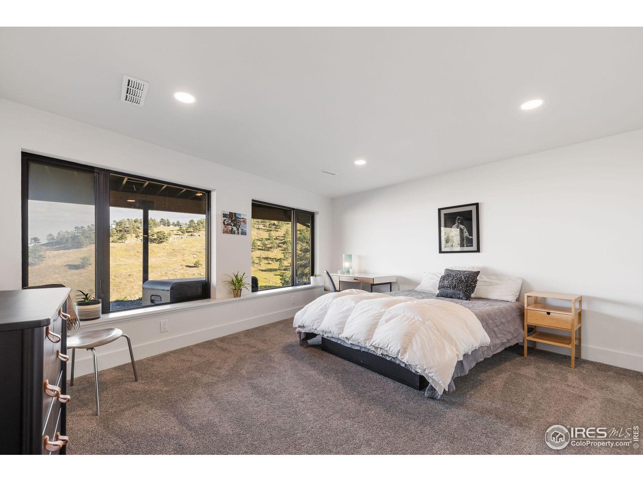 5880 Olde Stage Road Boulder, CO 80302 - Photo 42 of 50 a spacious bedroom with a large bed and a large window