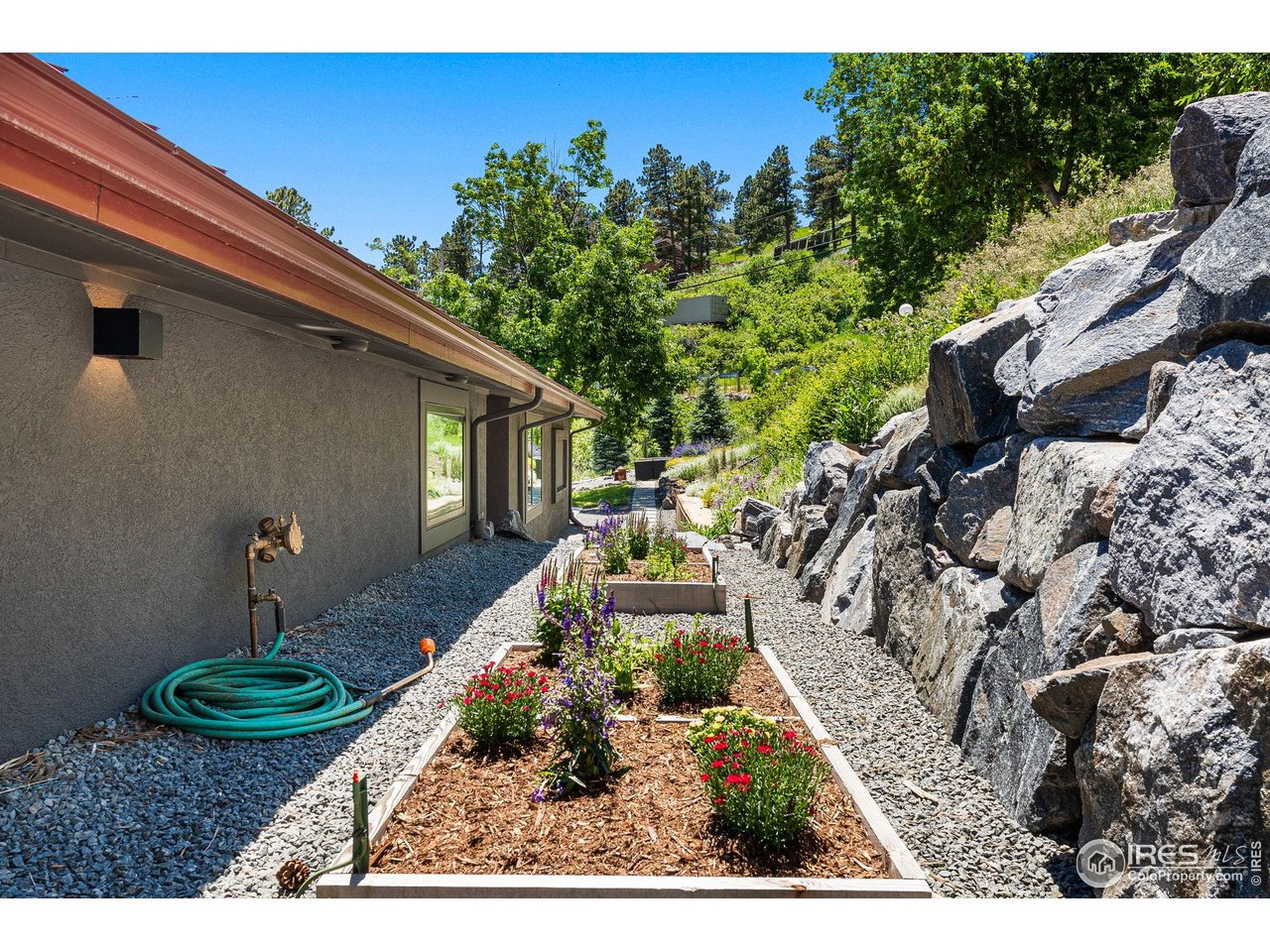 5880 Olde Stage Road Boulder, CO 80302 - Photo 48 of 50 a view of a backyard with table and chairs potted plants and large tree
