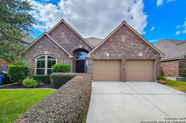 a front view of a house with a garden and plants