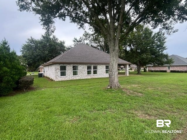 23348 Dundee Circle Foley, AL 36535 - Photo 3 of 21 Back of house featuring a lawn and a shingled roof