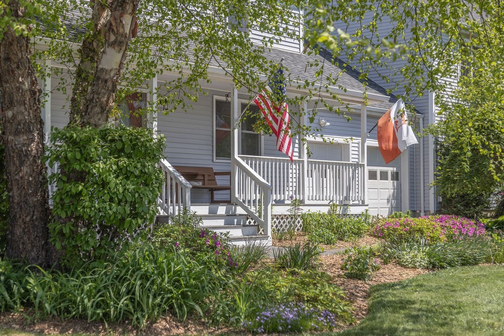 a view of a house with a yard and garden