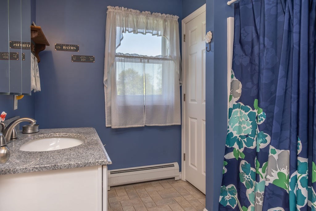 188 State Road Whately, MA 01373 - Photo 10 of 42 a bathroom with a granite countertop sink a mirror and a shower