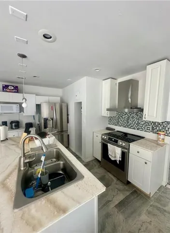 a kitchen that has a sink and a stove