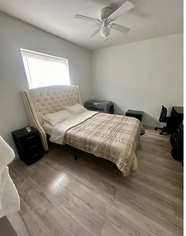 a bedroom with bed and a chandelier