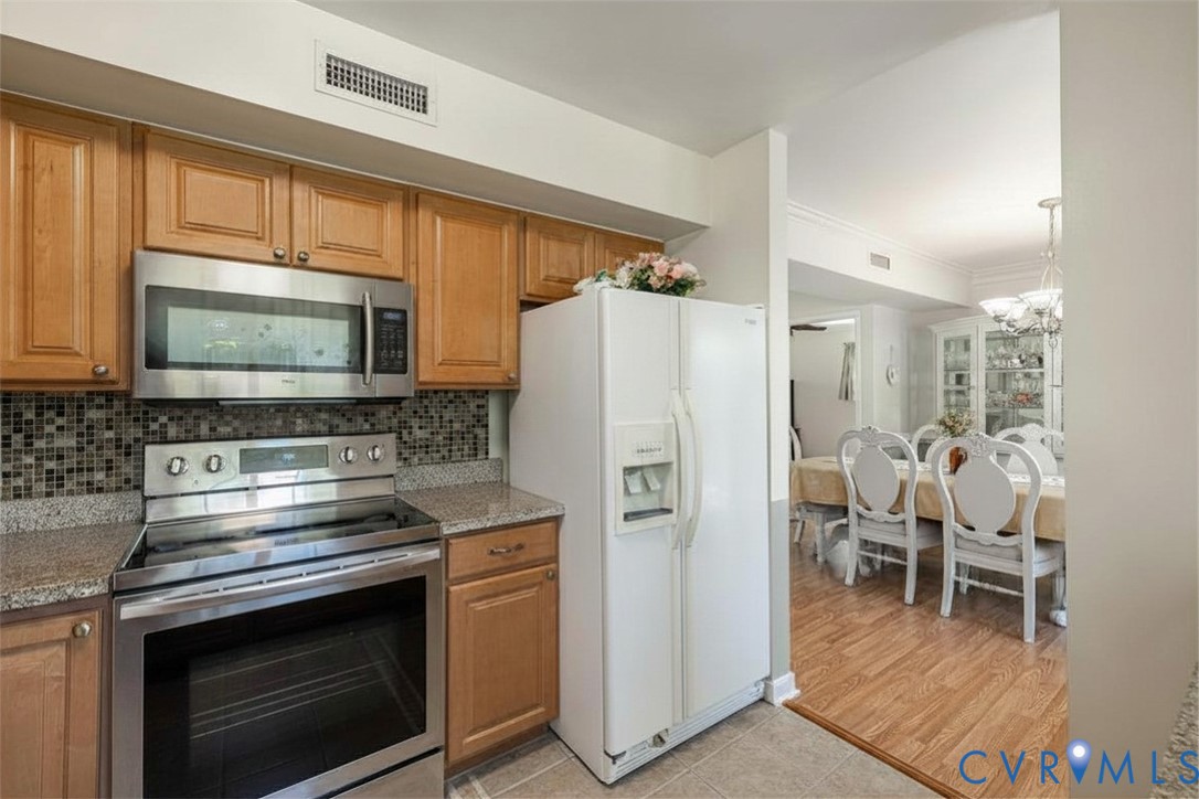 9217 Fisk Road Richmond, VA 23229 - Photo 12 of 39 a kitchen with stainless steel appliances a stove a refrigerator and a microwave