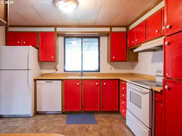 a kitchen with a stove a sink and a refrigerator