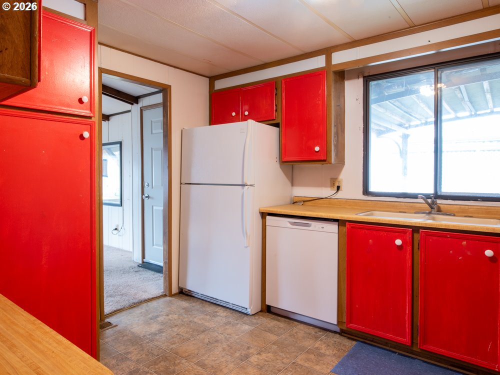 5335 Main Street Springfield, OR 97478 - Photo 12 of 43 a kitchen with a refrigerator a sink and a window