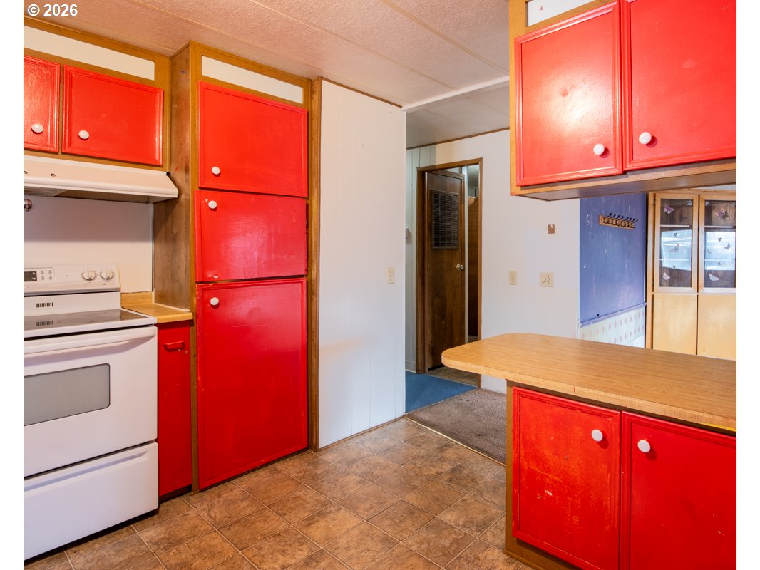 5335 Main Street Springfield, OR 97478 - Photo 14 of 43 a view of a kitchen with a stove and a kitchen island