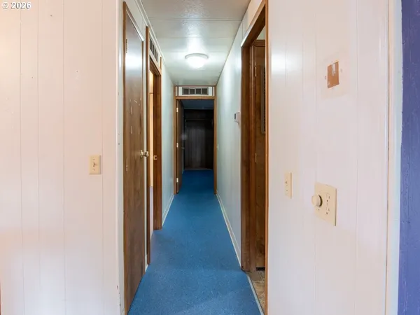 a view of an empty room with a kitchen