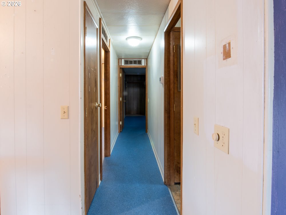 5335 Main Street Springfield, OR 97478 - Photo 15 of 43 a view of a hallway with wooden floor
