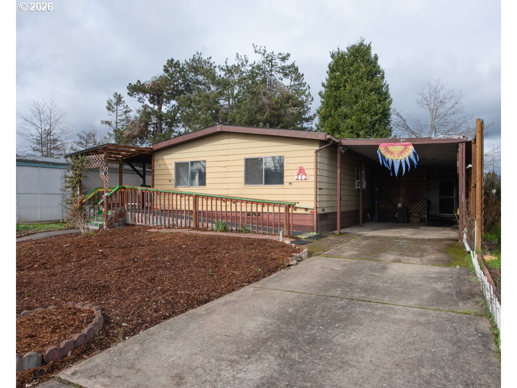 5335 Main Street Springfield, OR 97478 - Photo 2 of 43 a view of a house with a yard and garage