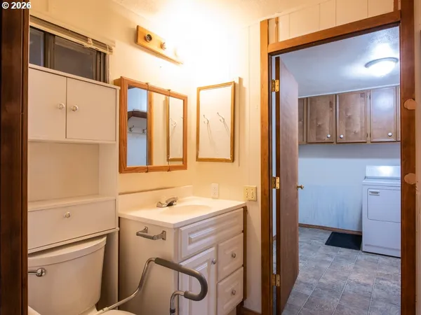 a bathroom with a sink a mirror and cabinets