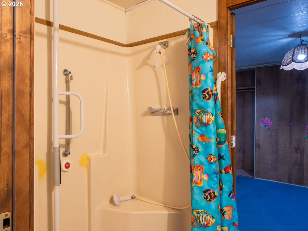 5335 Main Street Springfield, OR 97478 - Photo 29 of 43 a bathroom with a bathtub and a shower curtain