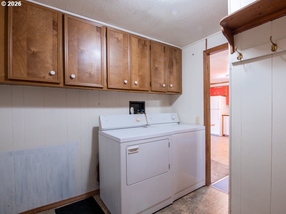5335 Main Street Springfield, OR 97478 - Photo 30 of 43 a utility room with cabinets washer and dryer