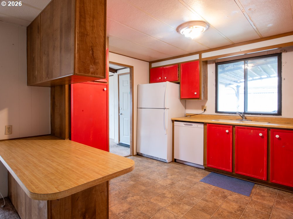 5335 Main Street Springfield, OR 97478 - Photo 33 of 43 a kitchen with refrigerator and window