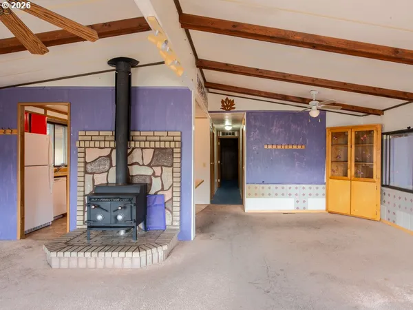 a kitchen with red cabinets a counter top space and a window