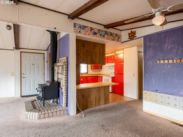 a kitchen with a refrigerator a sink and a window