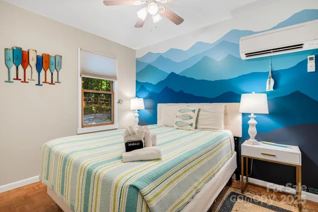 a bedroom with a bed and a chandelier