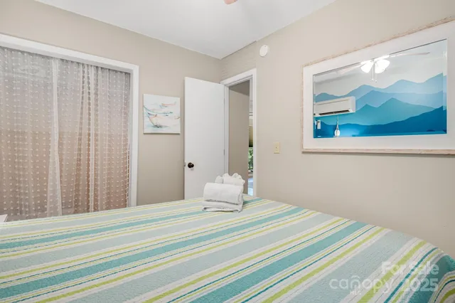 a bedroom with a bed and a painting on the wall