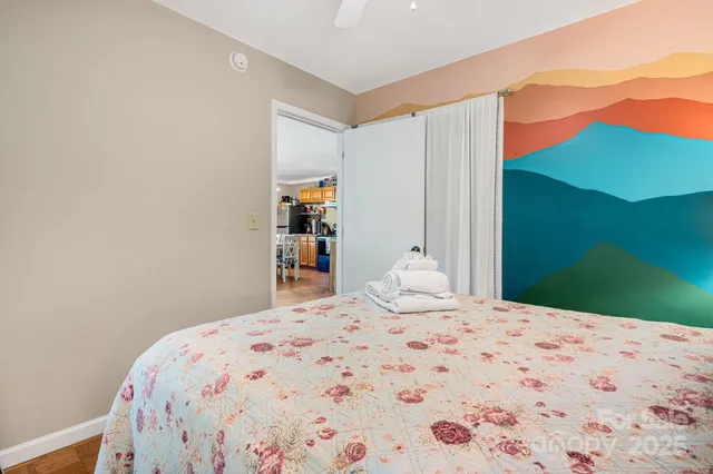 a bedroom with a bed and a bookshelf