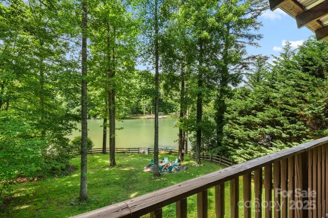 a view of a green field with wooden fence