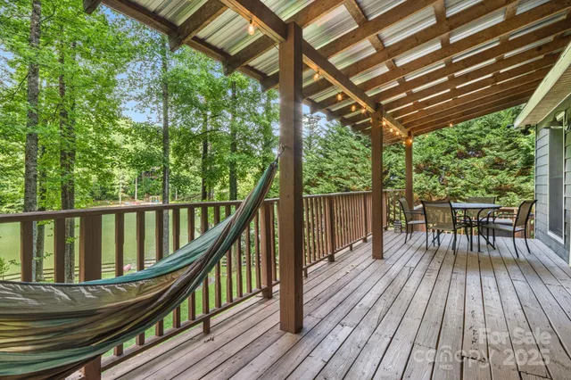 a view of porch with a table and chairs