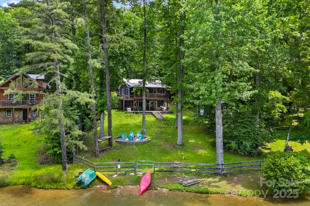 a view of a wooden deck with a big yard and potted plants