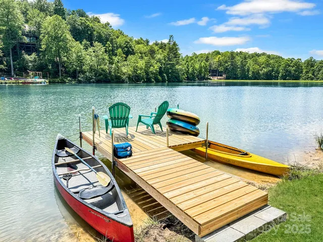 a view of a lake with couches chairs