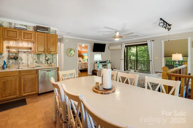 a large kitchen with a table chairs and refrigerator