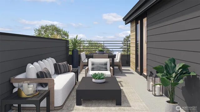 a view of a patio with couple of chairs and a potted plant