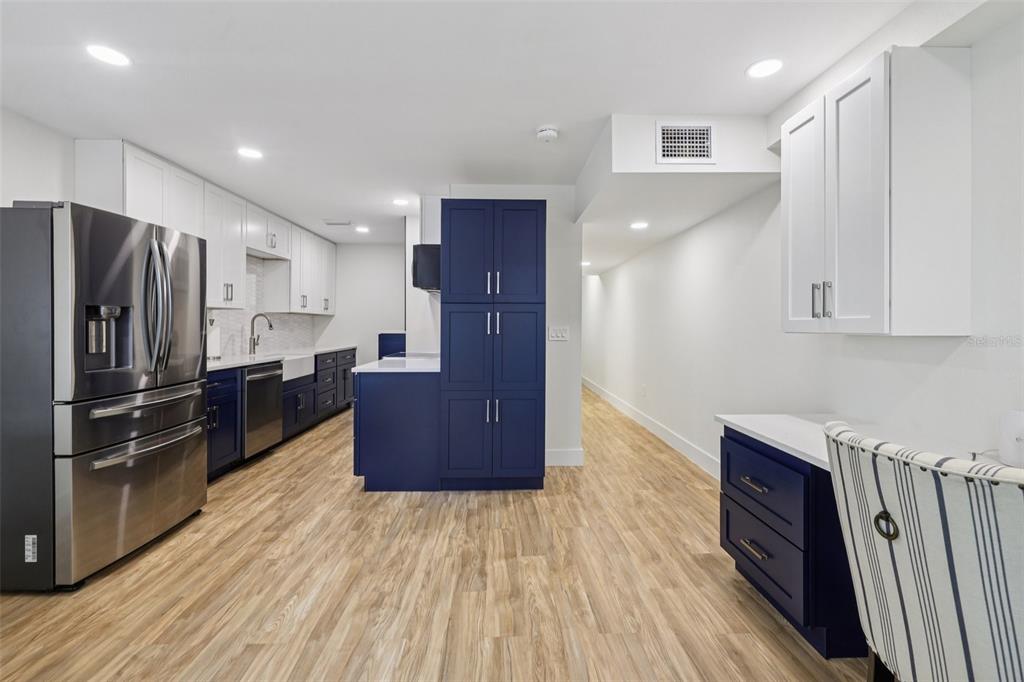4471 Vieux Carre Circle, Unit 4471 Tampa, FL 33613 - Photo 19 of 58 a kitchen with stainless steel appliances a refrigerator and wooden cabinets
